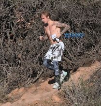 Justin Bieber shirtless run in Los Angeles. pop singer tattoos workout WENN