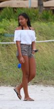 Sasha Obama beach in Miami President Obama's 15-year-old daughter Saturday afternoon. surrounded by secret service agents in plain clothes and hotel security. black bikini top print shorts white off the shoulder top SplashNews