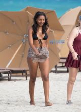 Sasha Obama beach in Miami President Obama's 15-year-old daughter Saturday afternoon. surrounded by secret service agents in plain clothes and hotel security. black bikini top print shorts white off the shoulder top SplashNews