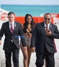 Sasha Obama beach in Miami President Obama's 15-year-old daughter Saturday afternoon. surrounded by secret service agents in plain clothes and hotel security. black bikini top print shorts white off the shoulder top SplashNews