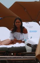 Sasha Obama beach in Miami President Obama's 15-year-old daughter Saturday afternoon. surrounded by secret service agents in plain clothes and hotel security. black bikini top print shorts white off the shoulder top SplashNews