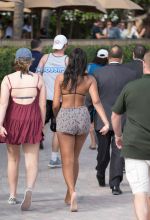 Sasha Obama beach in Miami President Obama's 15-year-old daughter Saturday afternoon. surrounded by secret service agents in plain clothes and hotel security. black bikini top print shorts white off the shoulder top SplashNews