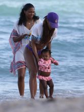 Teyana Taylor purple thong beach vacation in Miami. Baby Junie aka Iman Tayla Shumpert SplashNews