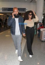 Solange Knowles husband, Alan Ferguson at LAX with highwater pants, camel-toe shoes and a beige top. SplashNews beard denim jacket white sneakers holding hands