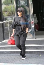 Blac Chyna Chase Bank Los Angeles, California. black Puma Sweatshirt black leggings sneakers pom pomp black oversize shades red Louis Vuitton SplashNews