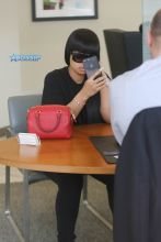 Blac Chyna Chase Bank Los Angeles, California. black Puma Sweatshirt black leggings sneakers pom pomp black oversize shades red Louis Vuitton SplashNews
