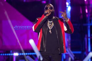 Hip-hop artist Rick Ross performs onstage at the MTV Woodies Awards during SXSW in Austin, Texas, USA. White Puma jogging suit diamond chains rings watch sunglasses SplashNews