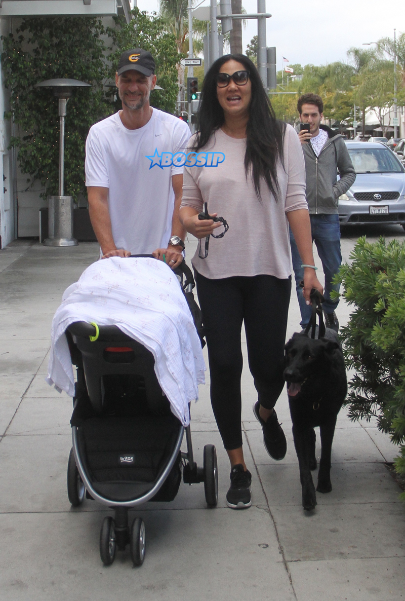 Kimora Lee Simmons and her husband Tim Leissner spotted out with their son Wolfe Leissner covered in his baby carriage WENN