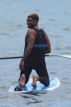 Usher and friends paddle boarding in Maui SplashNews