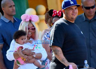 Rob Kardashian celebrates Father's day with Blac Chyna and their daughter Dream at the Happiest Place on earth. Rob and Chyna were happy to show their 7 months old different parts of the park including the small world ride and the Alice in Wonderland ride. They enjoyed snacks including a bag of sweets and an slurpee from ToonTown.