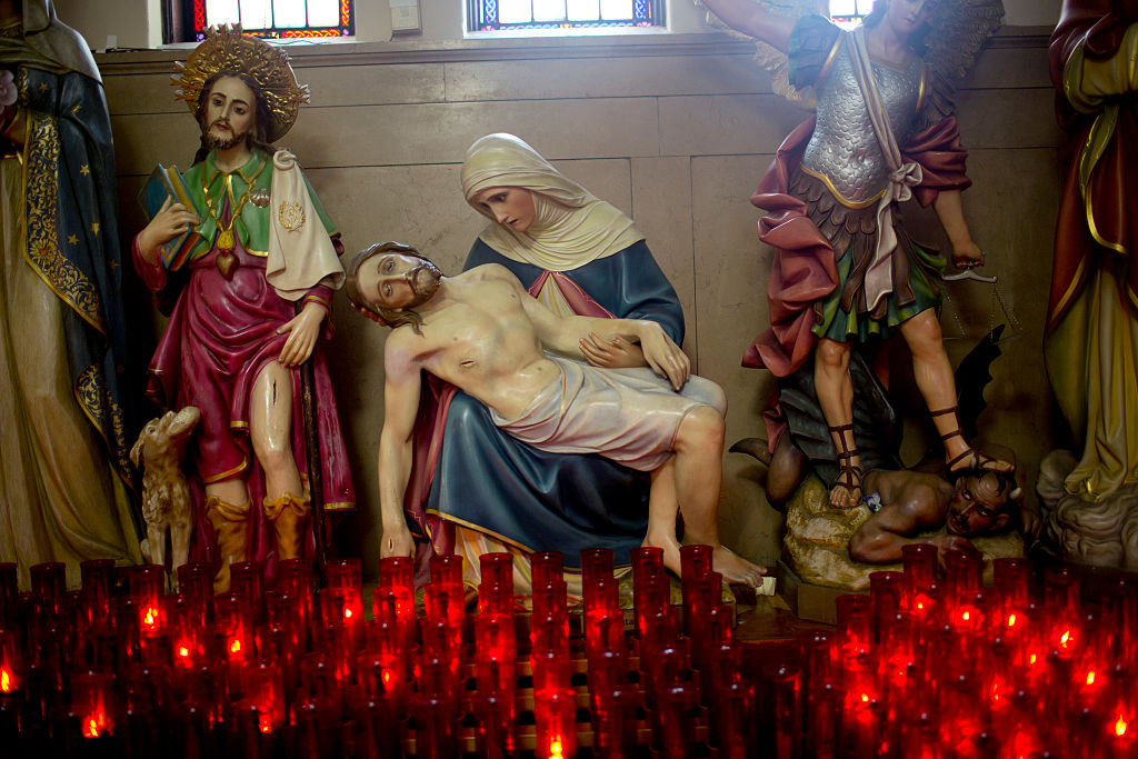 Street scenes from summertime in New York City. A statue of Jesus and Mary inside the Our Ladt Mt. Carmel Church in Williamsburg, Brooklyn.