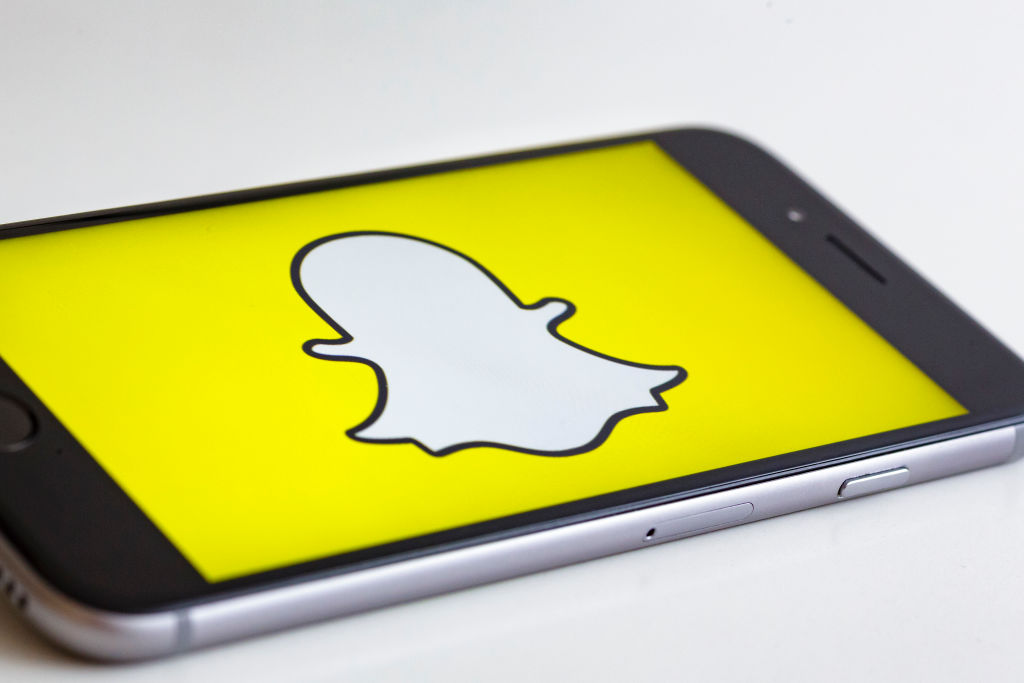 BERLIN, GERMANY - MAY 04: In this photo illustration the logo of Snapchat is displayed on a smartphone on May 04, 2017 in Berlin, Germany. 