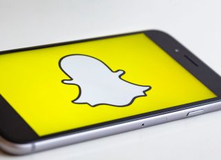 BERLIN, GERMANY - MAY 04: In this photo illustration the logo of Snapchat is displayed on a smartphone on May 04, 2017 in Berlin, Germany.