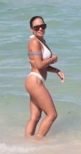 SplashNews American model Jordan Ozuna wears a white thong bikini at the beach in Miami Beach, FL. Tyga was seen courting Jordan in April on a date in Beverly Hills.