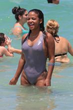 Christina Milian takes a swim in the ocean in a one piece swimsuit in Miami. SplashNews