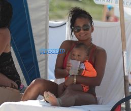 Singer Actress Christina Milian sizzles in a red bikini on the beach in Miami Beach in Florida. FAMA Press/SplashNews
