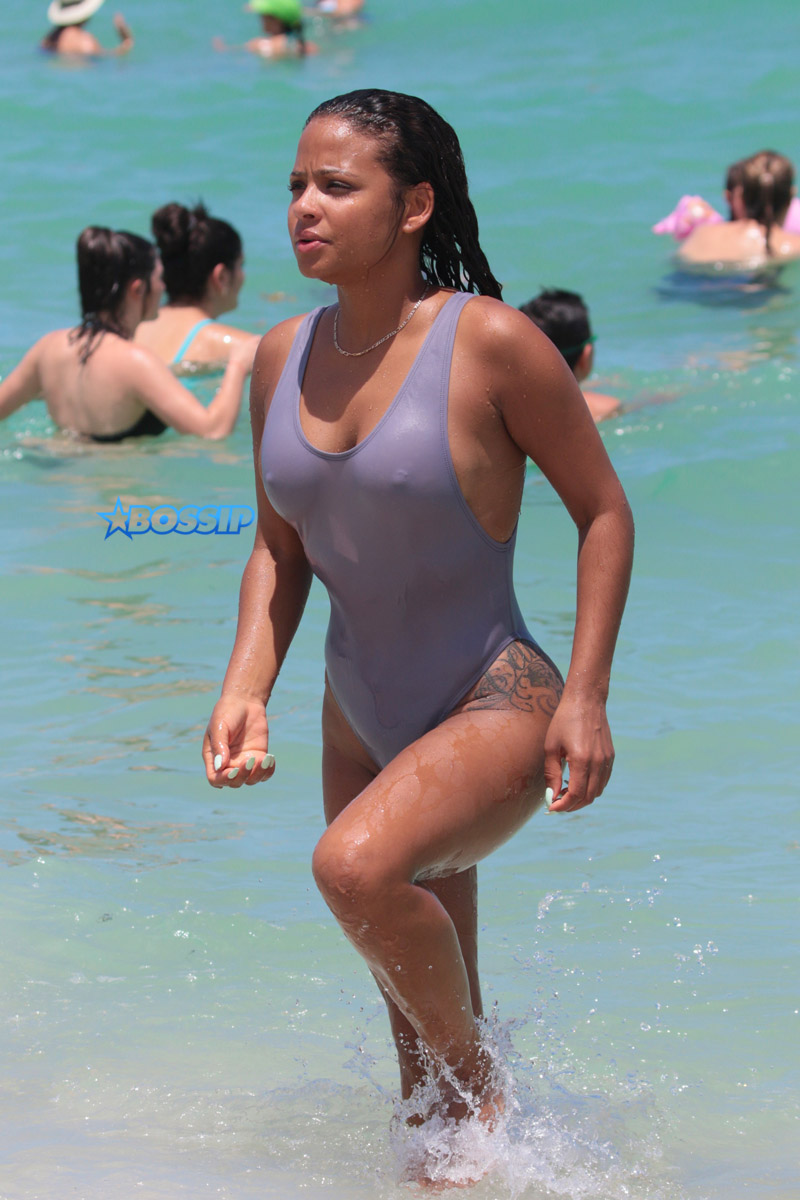 Christina Milian takes a swim in the ocean in a one piece swimsuit in Miami. SplashNews