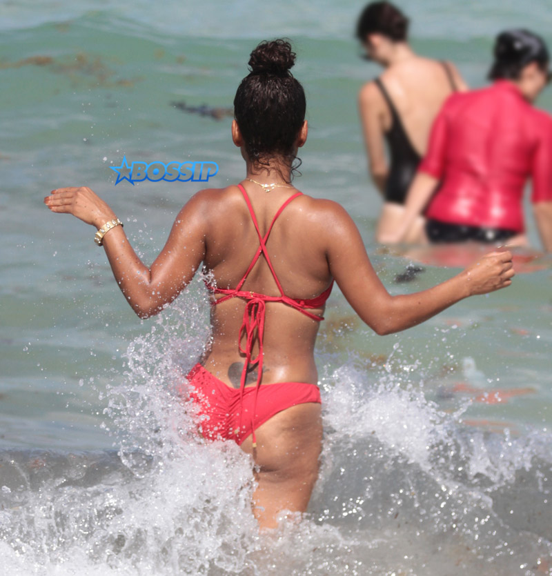 Singer Actress Christina Milian sizzles in a red bikini on the beach in Miami Beach in Florida.  FAMA Press/SplashNews