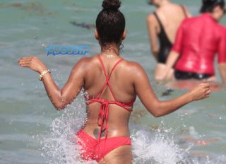 Singer Actress Christina Milian sizzles in a red bikini on the beach in Miami Beach in Florida. FAMA Press/SplashNews