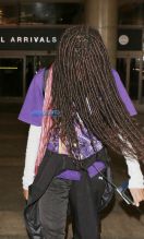 Willow Smith does her best impression of cousin It from the Addams Family as she uses her hair to hide her face as she arrives at LAX Airport in Los Angeles, Ca