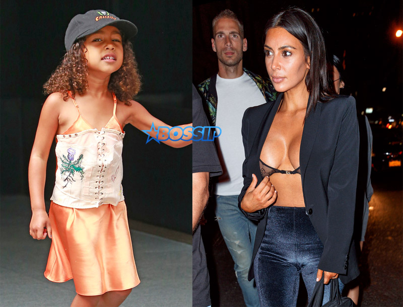 North West spotted in a cute orange summer dress and graffiti-laden white Yeezy sneakers in New York City SplashNews