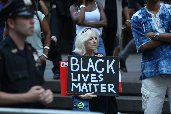 NEW YORK, USA - AUGUST 23 : A woman holds a banner reading 