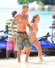 Topshop Heiress Chloe Green and her new boyfriend, "Hot Felon" Jeremy Meeks were spotted enjoying their holiday in Barbados on Saturday. The loved up couple took a wild ride on a Jetski in the light blue Caribbean waters . Afterwards they washed off in the shower together . Meeks showed off his tattoos as he wore a Gucci swimsuit