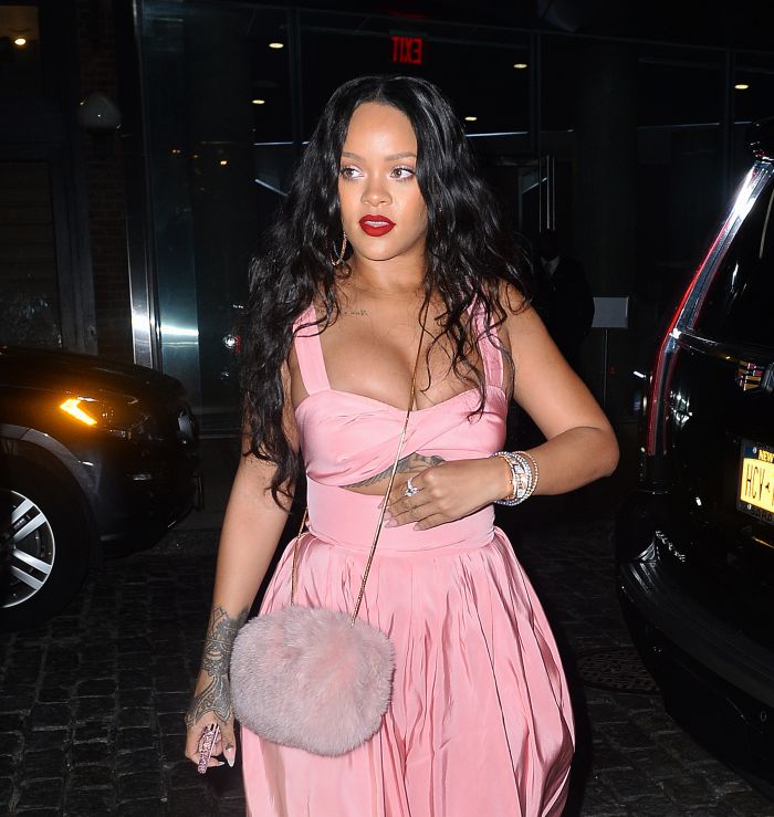 Rihanna looks striking in pink showing off her ample cleavage in NYC