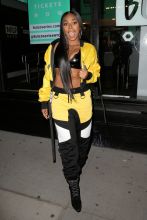 Singer Ashanti, wearing a bright yellow and black Michael Ngo track suit with black bra, exposes herself in the bitter cold outside Build Series in New York City, New York.