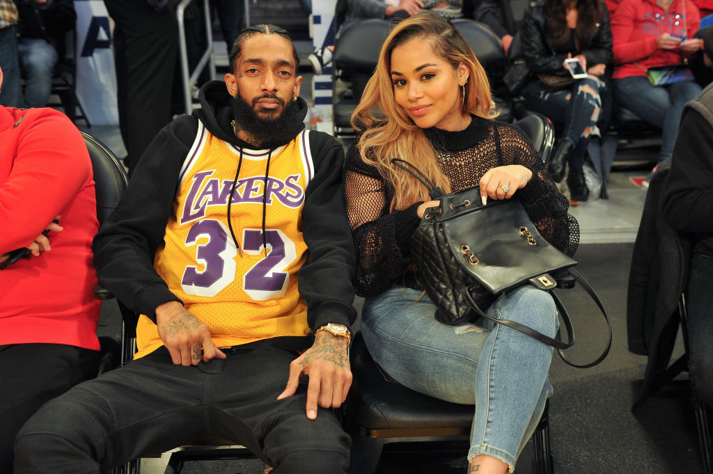 LOS ANGELES, CA - DECEMBER 25:  Rapper Nipsey Hussle and Lauren London attend a basketball game between the Los Angeles Lakers and the Minnesota Timberwolves at Staples Center on December 25, 2017 in Los Angeles, California.