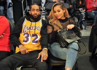 LOS ANGELES, CA - DECEMBER 25: Rapper Nipsey Hussle and Lauren London attend a basketball game between the Los Angeles Lakers and the Minnesota Timberwolves at Staples Center on December 25, 2017 in Los Angeles, California.