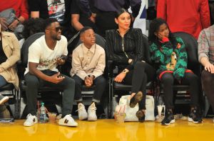DECEMBER 25: (L-R) Comedian Kevin Hart, son Hendrix Hart, wife Eniko Parrish and daughter Heaven Hart attend a basketball game between the Los Angeles Lakers and the Minnesota Timberwolves at Staples Center on December 25, 2017 in Los Angeles, California.