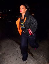 Rihanna leaving Avenue Nightclub early Saturday futuristic pair of Dior Sunglasses which she designed joined by OITNB star, Dascha Polanco, in a tight red and yellow dress. Rihanna covered her "engagement ring" w/ her Balenciaga hoodie as she walked out surround by security