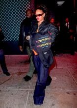 Rihanna leaving Avenue Nightclub early Saturday futuristic pair of Dior Sunglasses which she designed joined by OITNB star, Dascha Polanco, in a tight red and yellow dress. Rihanna covered her "engagement ring" w/ her Balenciaga hoodie as she walked out surround by security