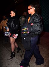Rihanna leaving Avenue Nightclub early Saturday futuristic pair of Dior Sunglasses which she designed joined by OITNB star, Dascha Polanco, in a tight red and yellow dress. Rihanna covered her "engagement ring" w/ her Balenciaga hoodie as she walked out surround by security