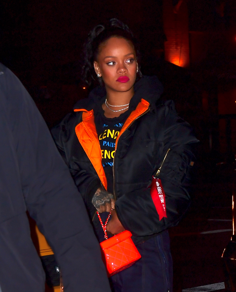 Rihanna leaving Avenue Nightclub early Saturday futuristic pair of Dior Sunglasses which she designed joined by OITNB star, Dascha Polanco, in a tight red and yellow dress. Rihanna covered her "engagement ring" w/ her Balenciaga hoodie as she walked out surround by security