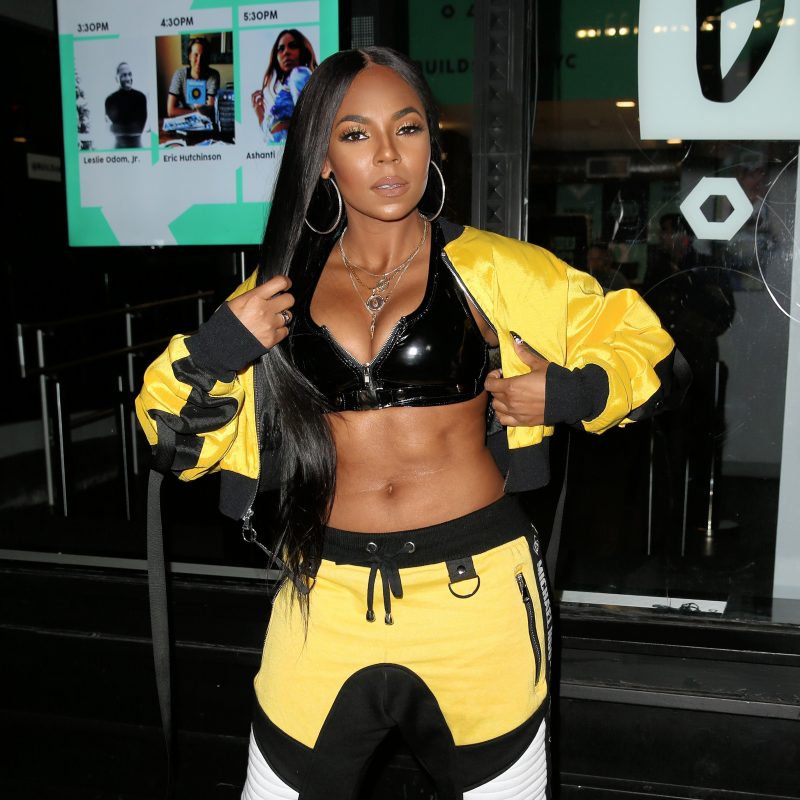 Singer Ashanti, wearing a bright yellow and black Michael Ngo track suit with black bra, exposes herself in the bitter cold outside Build Series in New York City, New York.