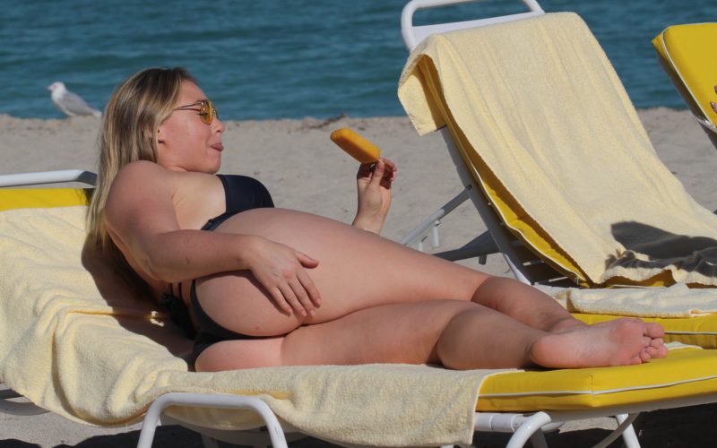 uk plus size model Iskra Lawrence was eating a popsicle while soaking up the sun in her lounger.