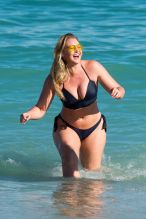 Iskra Lawrence shows off her curves in a bikini on the beach in Miami while enjoying herself with girl pals. The British model took a dip in the ocean under the Florida sun