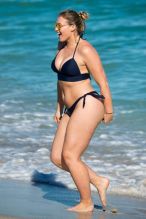 Iskra Lawrence shows off her curves in a bikini on the beach in Miami while enjoying herself with girl pals. The British model took a dip in the ocean under the Florida sun