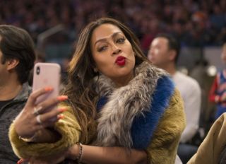 Lala Anthony sits court side at Madison Square Garden as her husband, Oklahoma City Thunder forward Carmelo Anthony #7 plays his former team, the NY Knicks.