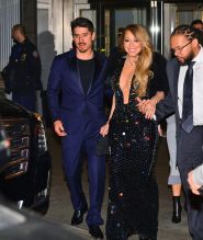 Mariah Carey is all smiles as she holds her boyfriend Bryan Tanaka's hand while leaving the Clive Davis pre-grammy party in NYC