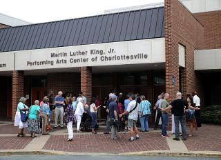 CHARLOTTESVILLE, VA - AUGUST 27: Residents arrive for a 'community recovery' town hall meeting conducted by the Department of Justice's Community Relations Service at the Dr. Martin Luther King Jr. Performing Arts Center at Charlottesville High School August 27, 2017 in Charlottesville, Virginia. The meeting follows an August 21 city council meeting that was overtaken by angry residents who screamed and cursed at councilors over the city's response to the "Unite the Right" white supremacist rally. That August 12 rally devolved into street violence and left one counter-protester dead and two state trooper killed in a helicopter crash.