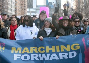 Whoopi Goldberg, Michael Moore and Rosie Perez march in the Women's March of New York City on January 20, 2018.