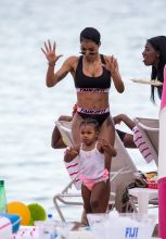 Teyana Taylor is seen with her daughter Iman Tayla Shumpert Jr. on the beach in Miami