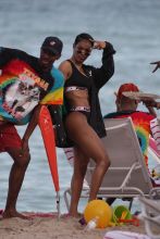 Actress Teyana Taylor, 27, in a black bikini by Fade2Fit at the beach in Miami Beach, FL.
