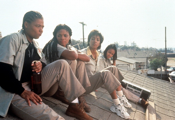 Queen Latifah, Kimberly Elise, Vivica Fox and Jada Pinkett all sitting on the roof of a house in a scene from the film 'Set It Off', 1996