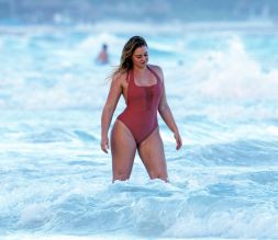 Iskra Lawrence in a one piece bathing suit while the beach in Tulum Mexico.