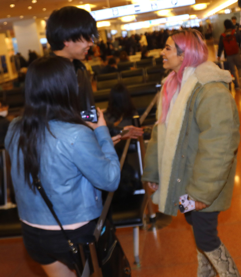Kim Kardashian is all smiles as she poses with fans upon landing in Tokyo with her sisters for their first family trip overseas together in 2018. Kim was very happy to take some photos with her loyal fans as she flashed a peace sign and was spotted in customs with Kourtney and Khloe as they had their entourage and luggage with them. The girls made their way through the airport as a group and headed out of the airport for their first night in the city.