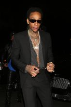 Rapper Wiz Khalifa smokes a cigarette as he attends Floyd Mayweather's 41st birthday party held at The Reserve night club in Los Angeles